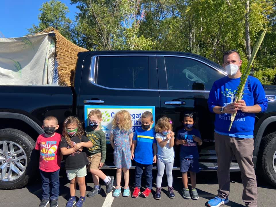 Rabbi Nathan outside of our "Mobile Sukkah" with the Tikvah Tots.